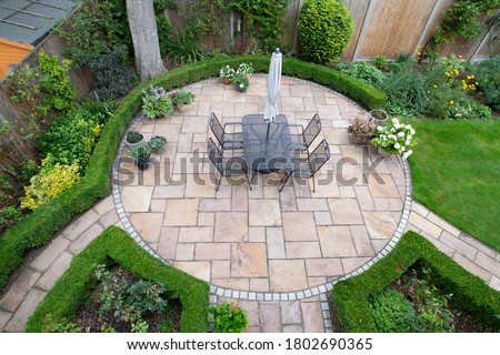 circular garden patio with freshly jet washed paving stones Royalty-Free Stock Photo #1802690365