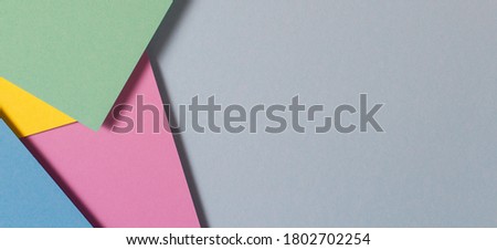 Abstract color papers geometry flat lay composition background with blue, green, pink, purple, yellow color tones