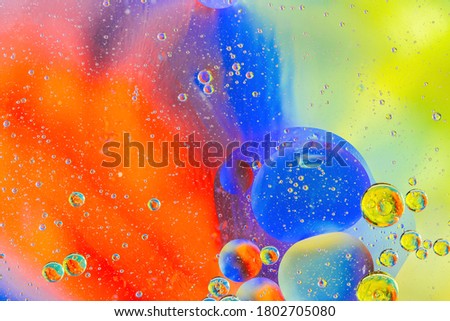 Abstract colorful Background Oil in Water with colorful gradient colors. Fantastic structure of colorful oil bubbles. Chaotic motion. Psychedelic pattern image rainbow colored. Macro shot. Royalty-Free Stock Photo #1802705080