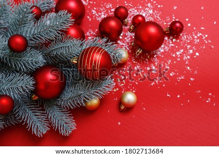 Christmas background in red and green. Nobody. Decorative composition: Christmas tree, large, small balls of red and gold, artificial snow. Top view. Horizontal, Space for text. Happy New Year theme.