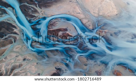 A glacial rivers from above. Aerial photograph of the river streams from Icelandic glaciers. Beautiful art of the Mother nature created in Iceland. Wallpaper background high quality photo Royalty-Free Stock Photo #1802716489