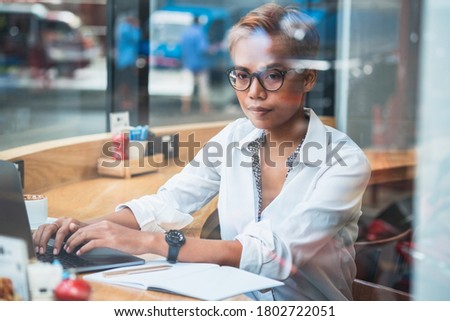 Business woman working behind glass stock photo