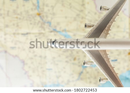 Airplane over an aeronautical map with charts. Travel around the world concept