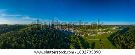 Inspirational aerial landscape, summer green forest and a lovely town in a valley at the recreation aera of the Swabian Alb in germany.