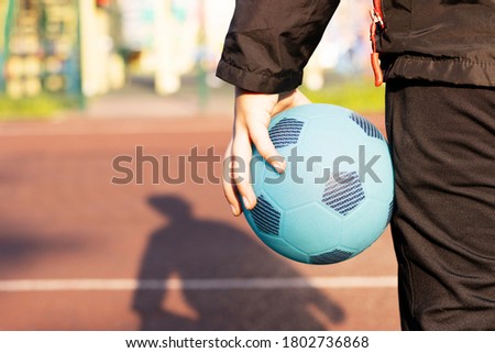 baby boy holding a blue ball in his hands. love of sport. healthy lifestyle