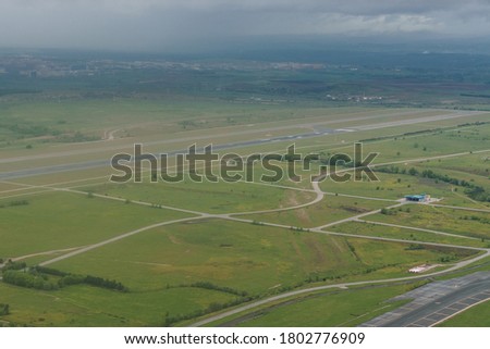 Aerial view of one of the runways at Adolfo Suarez airport and surroundings on a cloudy day. Travel.
