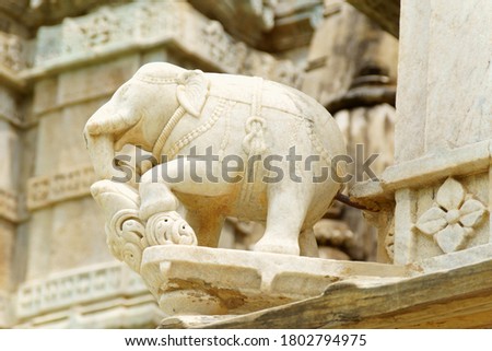 Stone elephant statue from the decorations of the facade of Chaumukha Jain Temple in Ranakpur, Rajastahn, India. Royalty-Free Stock Photo #1802794975