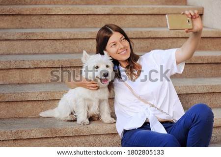 Woman making her selfie with her dog