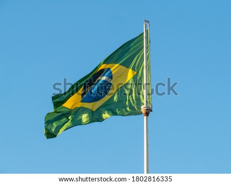 Brazil flag fluttering in the wind. In the center of the flag with the words "order and progress" Royalty-Free Stock Photo #1802816335