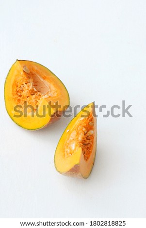 Raw pumpkin cut on white background selective focus