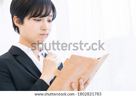 Beautiful young asian woman who fills out a schedule book