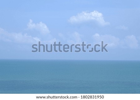 Landscape image of blue sky and white clouds over the ocean on sunny day.