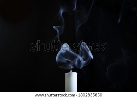 Candle with smoke in black background smoke art