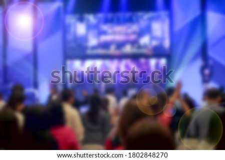 Worship God on Sunday with joy. /Picture blur effect./Concert in low light and lens flare.