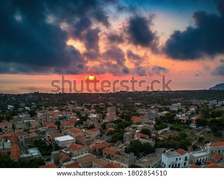 Iconic scenery over the old historical town of Areopoli Lakonia, Greece against a dramatic sunset sky