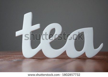 Acrylic Word Tea on Wooden Table