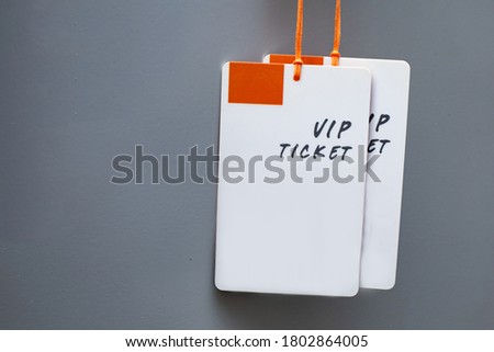 Plastic labels or tag showing the word "VIP Ticket" on gray background. with copy space on the left.