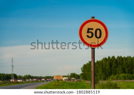 50 speed limit orange road sign on country road