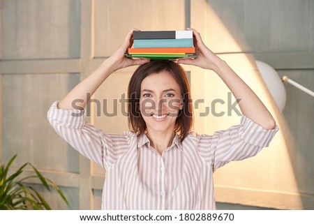 Univetsity research. Pretty woman working at home. Portrait with books on head. Indoors office. Learning language. Female human lifestyle. Student eyes. Education concept. Lockdown lessons Royalty-Free Stock Photo #1802889670
