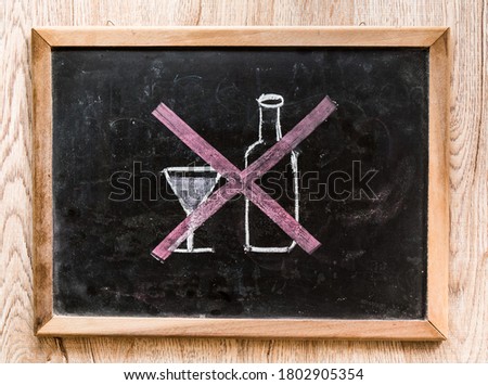 Cross sign on picture of glass and bottle   ,in door   Chiangmai Thailand Royalty-Free Stock Photo #1802905354