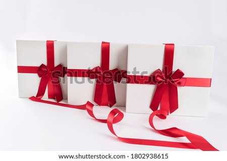 a gift box tied with a red ribbon string