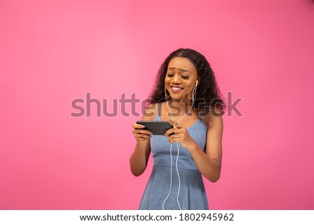 pretty black lady watching a video on her phone