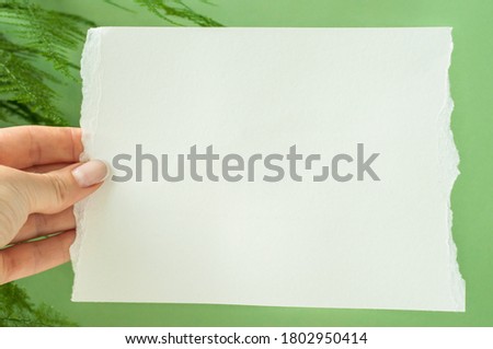 Empty white paper on green background