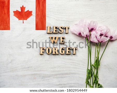 Lest We Forget. Congratulatory phrase. Beautiful greeting card. Close-up, view from above. National holiday concept. Congratulations for family, relatives, friends and colleagues