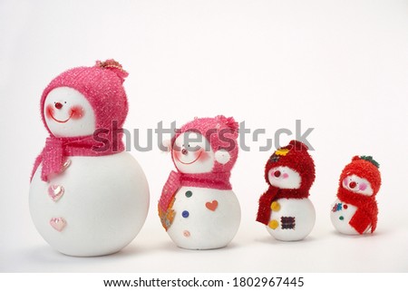 a photograph of a snowman in a red hat