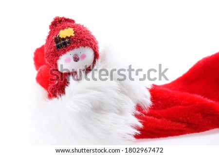 a photograph of a snowman in a red hat