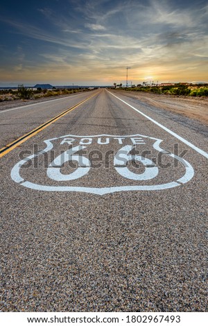 U.S. Route 66 horizontal road sign at sunset, Amboy, California, USA Royalty-Free Stock Photo #1802967493