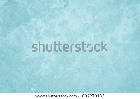 Pastel blue paint concrete stone texture for background in summer wallpaper. Cement and sand wall of tone vintage. Concrete abstract wall of light cyan color, water color crack cement texture design.