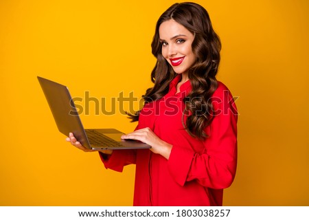 Profile photo of attractive wavy lady hold notebook hands texting colleagues reading corporate email self-confident worker wear red office shirt isolated yellow bright color background