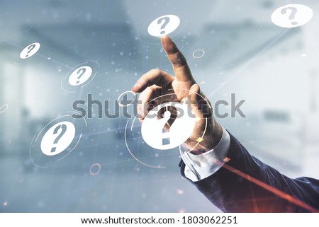 Man hand clicks on abstract virtual question mark hologram on blurred office background, future technology concept. Multi exposure Royalty-Free Stock Photo #1803062251