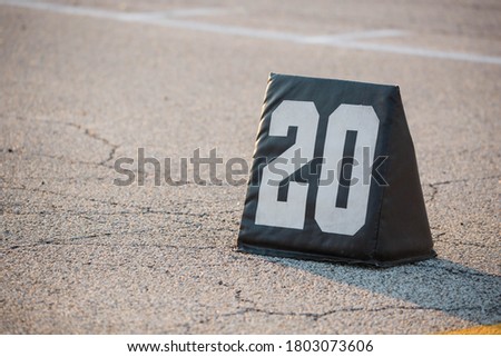 twenty yard line marker ready for rehearsal at marching band rehearsal