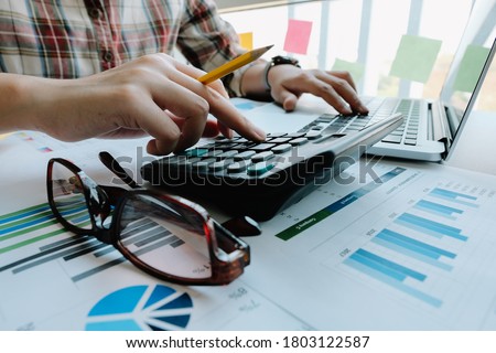 Woman accountant or bookkeeper use calculator for calculation financial report. Work for safe at home