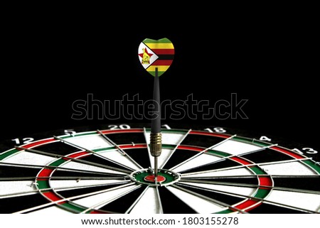 The flag of Zimbabwe is featured on the dart board game, the concept of achieving goals.