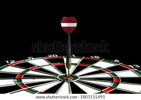 The flag of Latvia is featured on the dart board game, the concept of achieving goals.