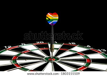 The flag of Gay pride Flag of South Africa is featured on the dart board game, the concept of achieving goals.