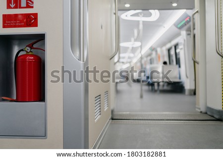 red  fire extinguisher in metro