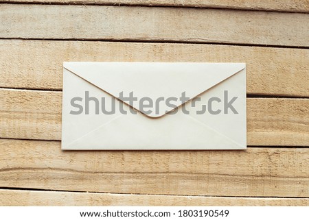 white envelopes on the wooden background
