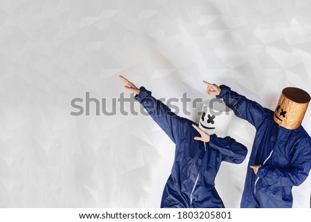Two man in suit on a white structural background is shown to the left in the free space for text or goods.  Interesting product advertisement.