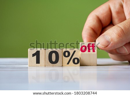 The hand turn wooden block and change word to 10% off. Sale background concept.