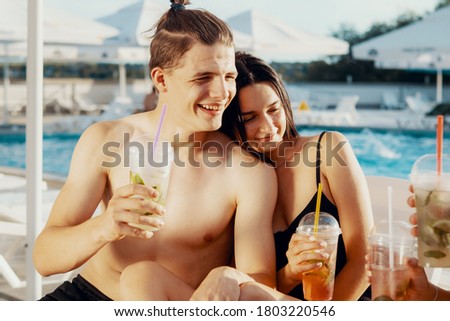 Positive couple resting in a swimming pool.Holiday concept
