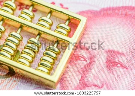 Long term investment for sustainable dividend growth, financial concept : Gold abacus on Chinese yuan note, depicts investor invest or makes a saving plan in assets for capital gain and tax incentives Royalty-Free Stock Photo #1803225757