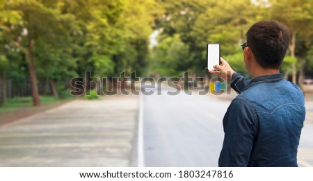 Man holding smartphone for take a something photo.Communication network,social media,online shopping or Business management concept.White or blank screen for decorate Advertising.View of copy space.