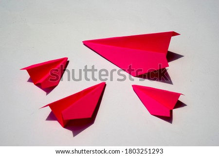 Pink Paper Plane or Paper Airplane Origami on white Background Top View with Place for Text, business competition concept