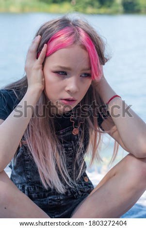 cute child girl portrait . Outdoor portrait of cute little girl in summer day. Portrait of a little girl with pink hair. Child 9-10 years old. Teenager