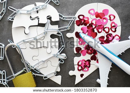 White heart-shaped puzzle. Heart affairs. Undivided love. Broken heart. The key to the heart. Closed heart on a lock. Concept love.