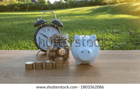 coin with  alarm clock and piggy bank, saving money. Most of the time looking for money. Saving ideas and investment budget, Creative ideas concept of saving money concept, Copy space